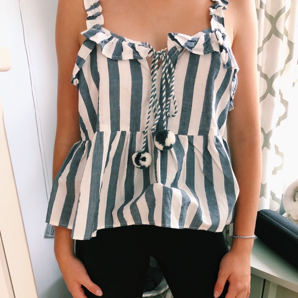 Blue and white striped tank top with pom poms.